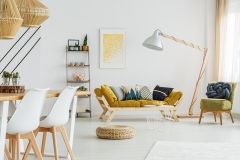 Round wicker footrest lying on the floor in living room